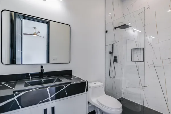 a bathroom with a sink toilet and shower