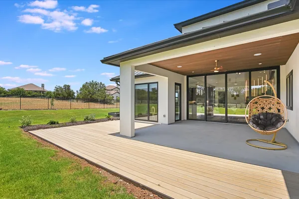 a view of a house with backyard porch and sitting area