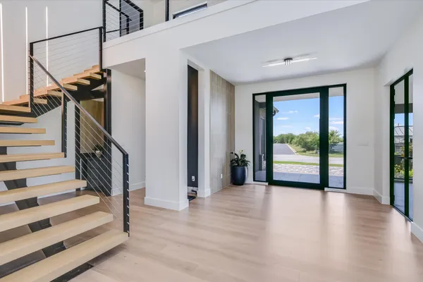 a view of entryway with wooden floor and stairs