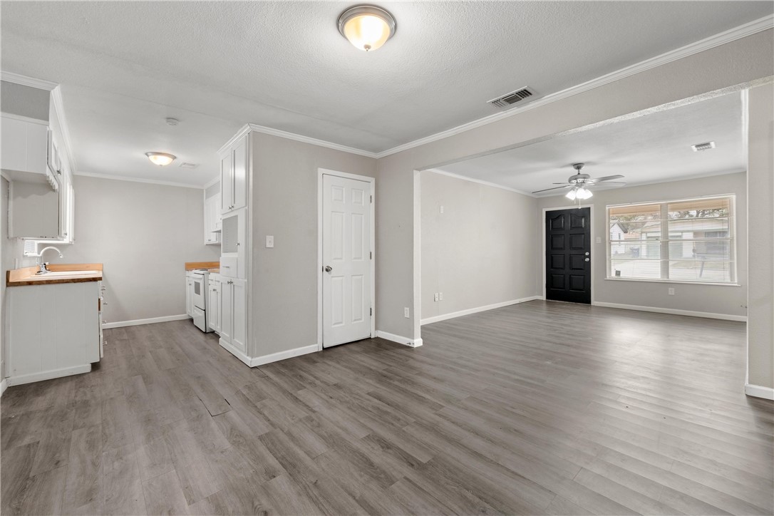 3234 Ferndale Drive Waco, TX 76706 - Photo 2 of 17 a view of a livingroom with wooden floor and a kitchen