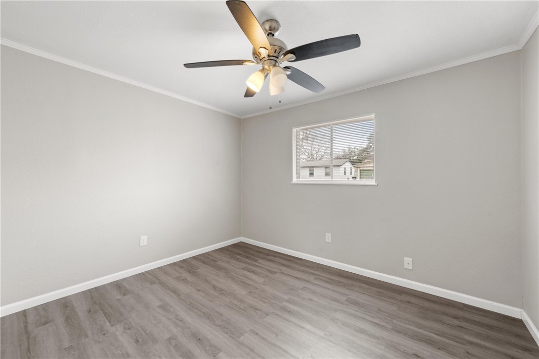 3234 Ferndale Drive Waco, TX 76706 - Photo 6 of 17 an empty room with wooden floor and ceiling fan