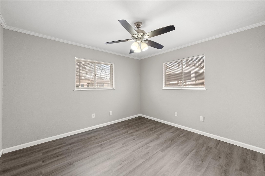3234 Ferndale Drive Waco, TX 76706 - Photo 7 of 17 a view of an empty room with wooden floor and a window