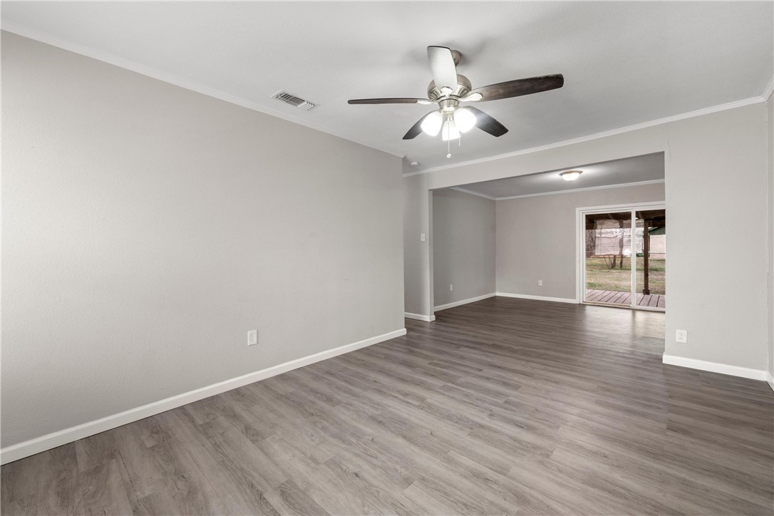 3234 Ferndale Drive Waco, TX 76706 - Photo 10 of 17 a view of an empty room with wooden floor and a ceiling fan