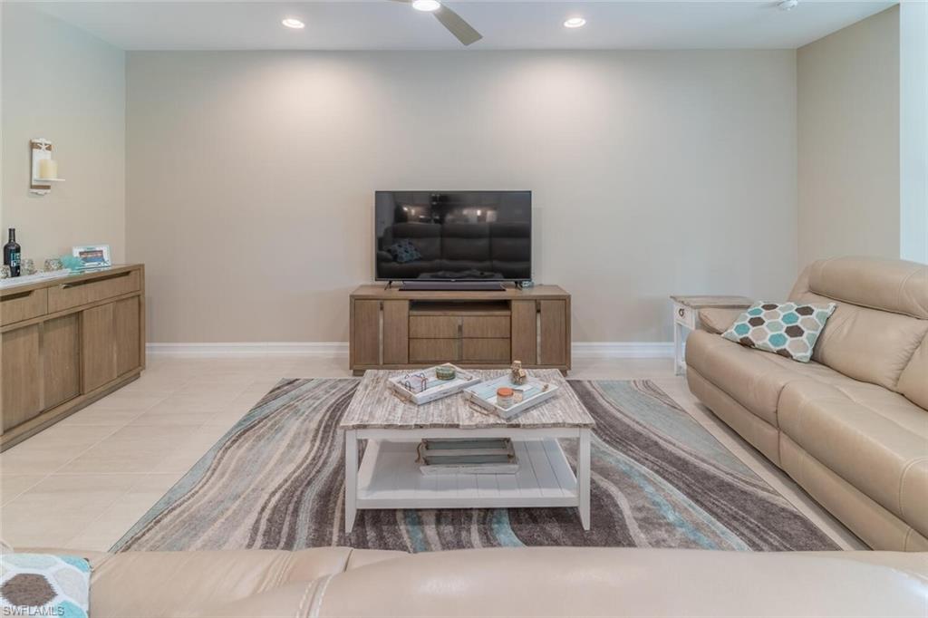 16366 Barclay Court Naples, FL 34110 - Photo 12 of 35 a living room with furniture and a wooden floor