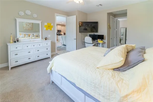 a bedroom with a bed and a dresser in it