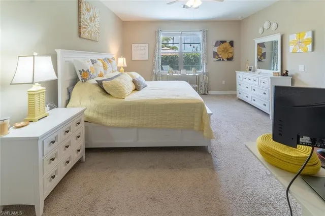 a spacious bedroom with a bed and wooden floor