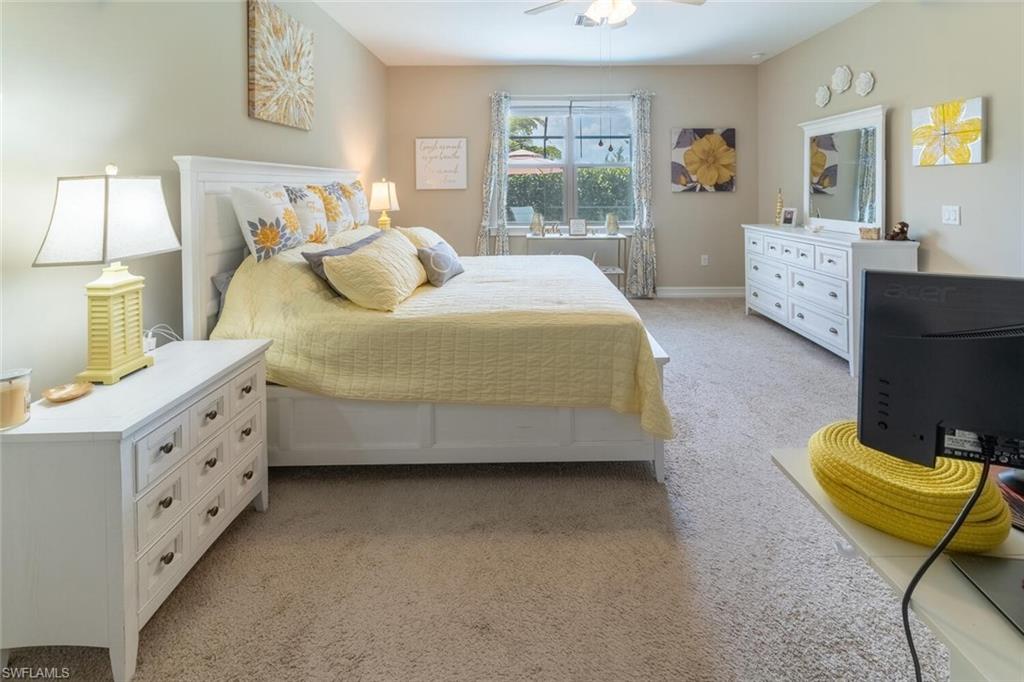 16366 Barclay Court Naples, FL 34110 - Photo 15 of 35 a spacious bedroom with a bed and wooden floor