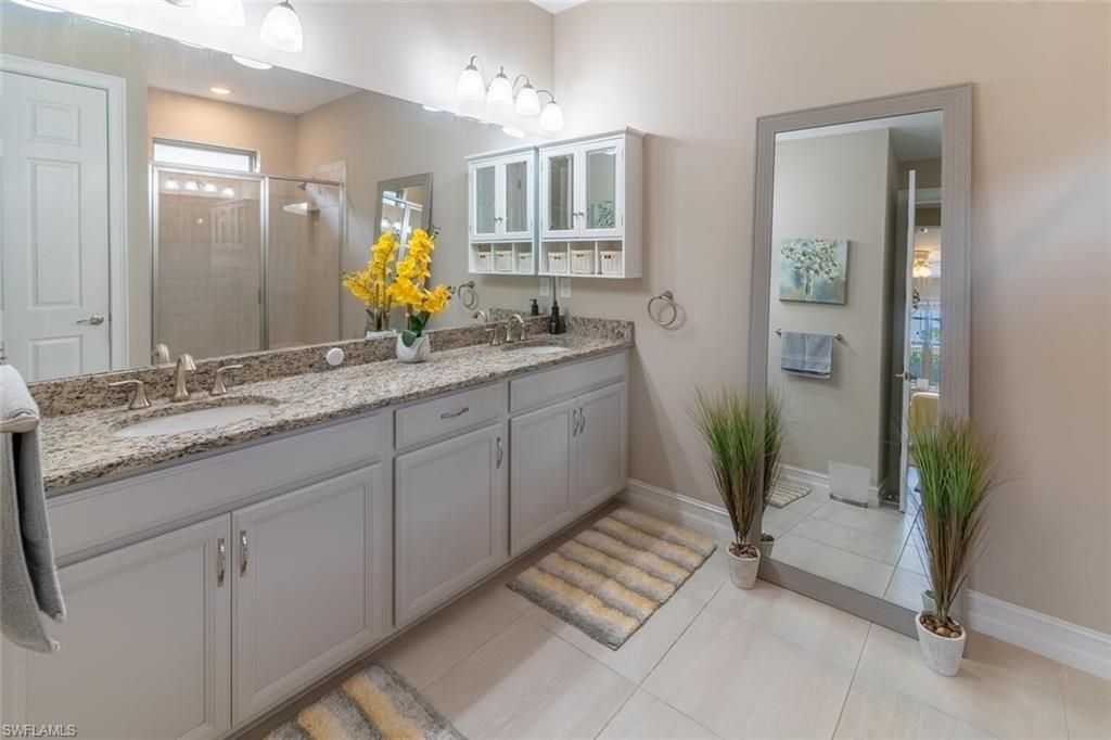 16366 Barclay Court Naples, FL 34110 - Photo 16 of 35 a bathroom with a granite countertop sink and a mirror
