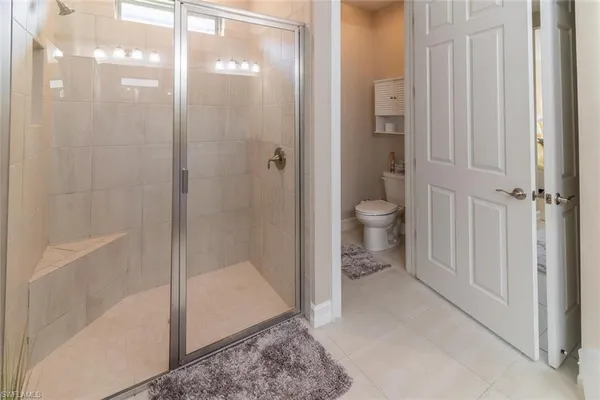 a bathroom that has a glass shower door