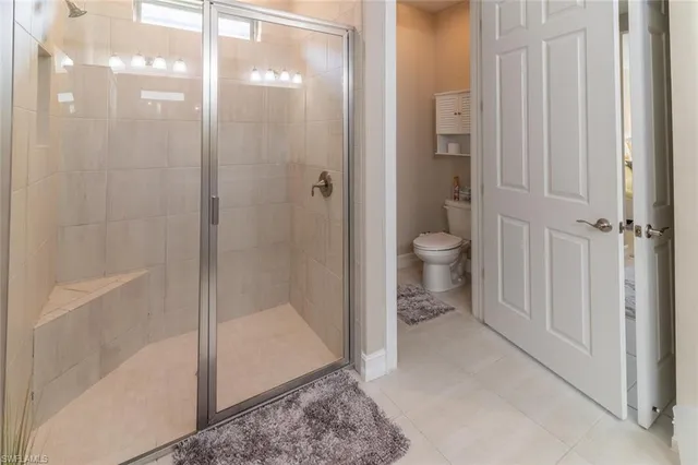 a bathroom that has a glass shower door