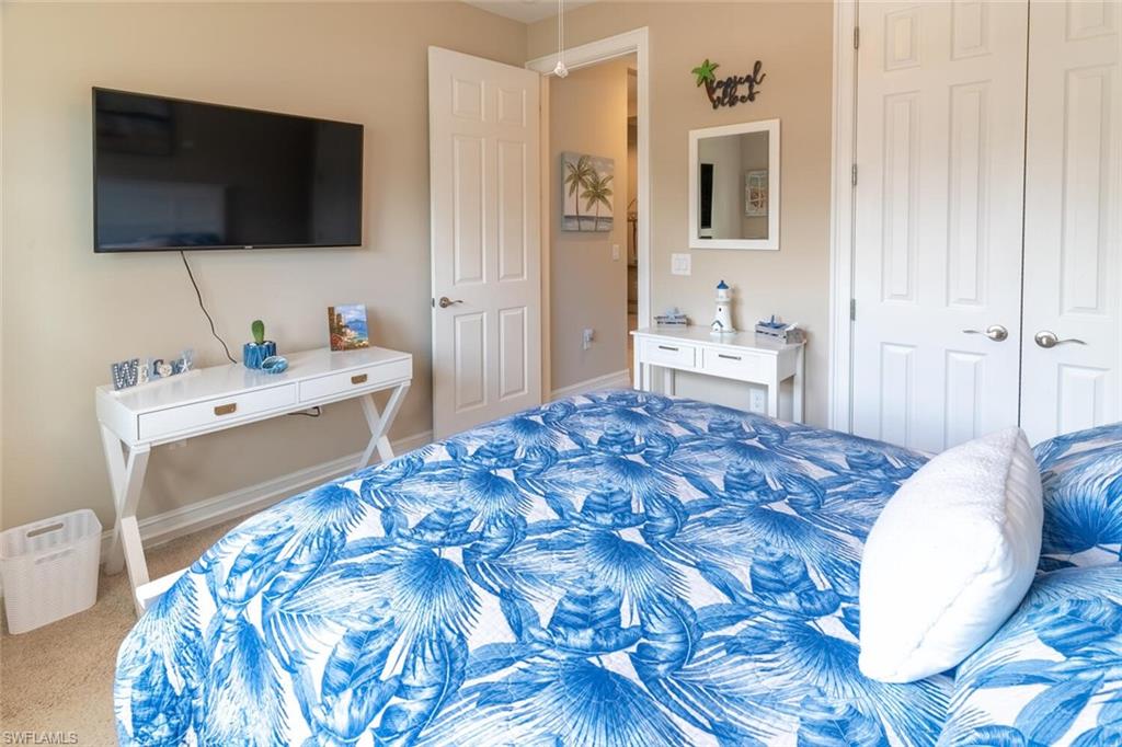 16366 Barclay Court Naples, FL 34110 - Photo 19 of 35 a bedroom with a bed and a flat screen tv