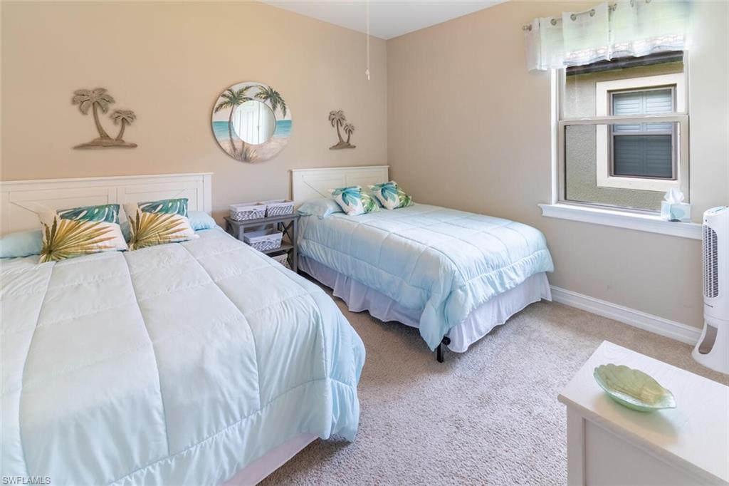 16366 Barclay Court Naples, FL 34110 - Photo 20 of 35 a bedroom with two beds and painting on the wall