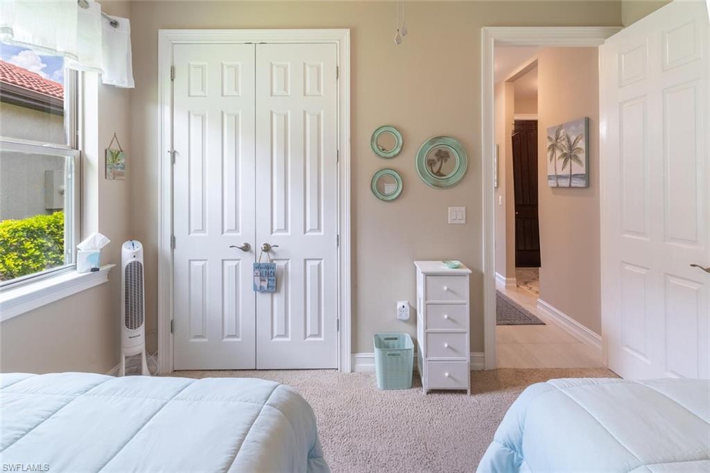 16366 Barclay Court Naples, FL 34110 - Photo 21 of 35 a bedroom with a bed and a window