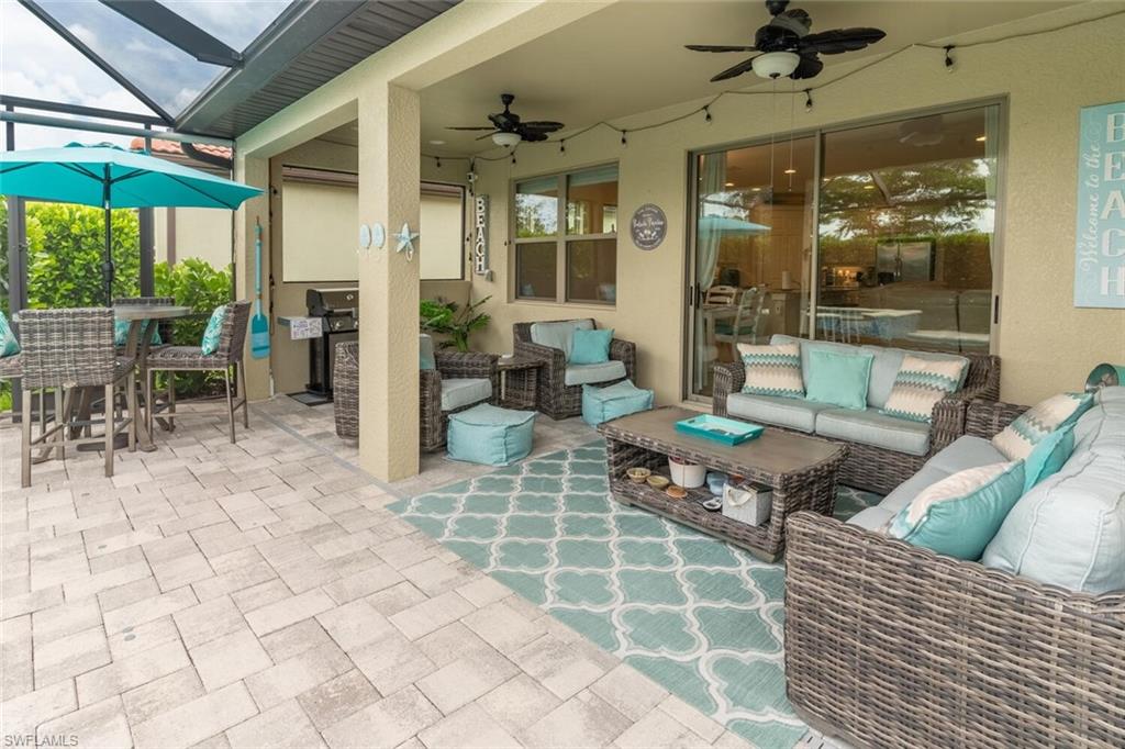 16366 Barclay Court Naples, FL 34110 - Photo 29 of 35 a outdoor space with lots of white furniture and glass door