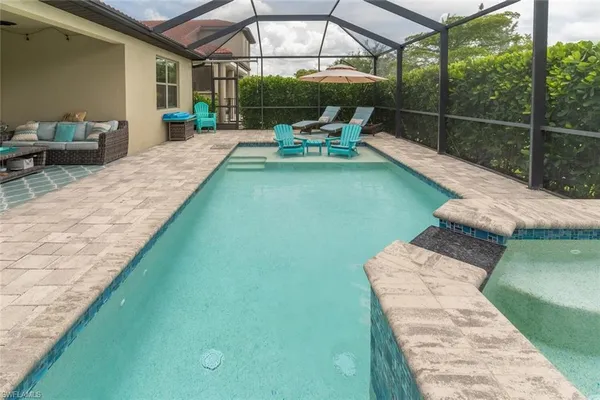a view of a patio with chairs next to a yard