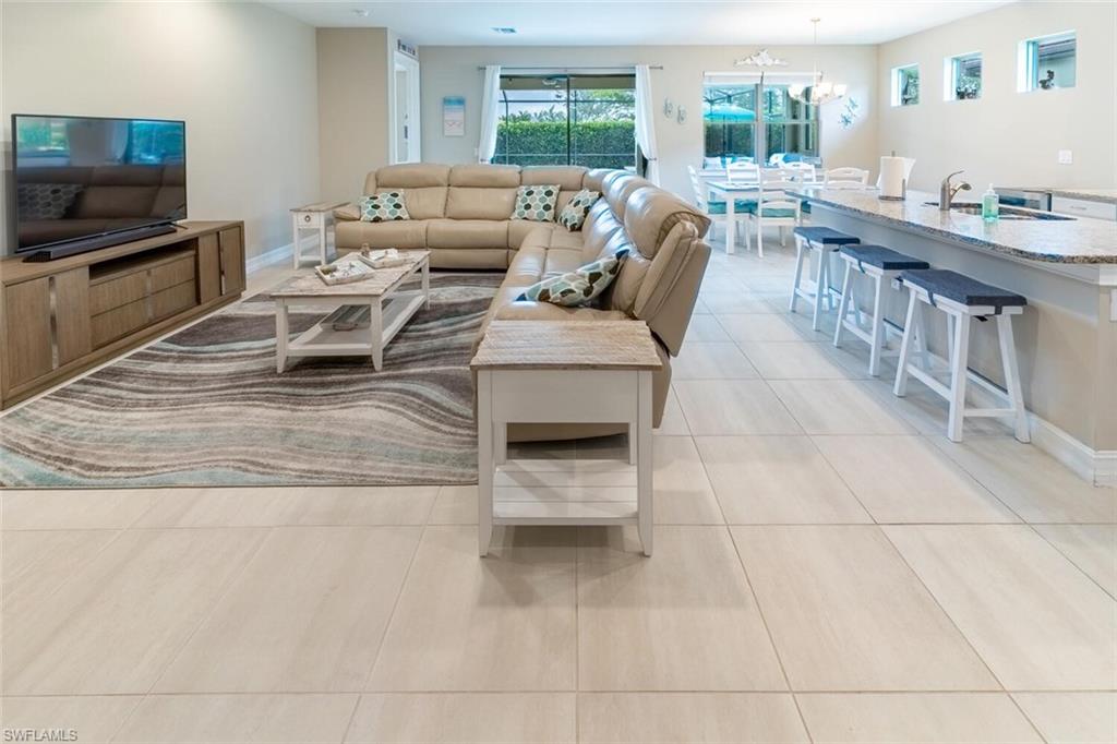 16366 Barclay Court Naples, FL 34110 - Photo 4 of 35 a living room with furniture and a flat screen tv
