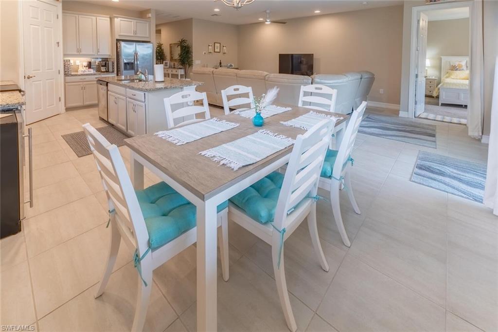 16366 Barclay Court Naples, FL 34110 - Photo 10 of 35 a view of a dining room with furniture and wooden floor