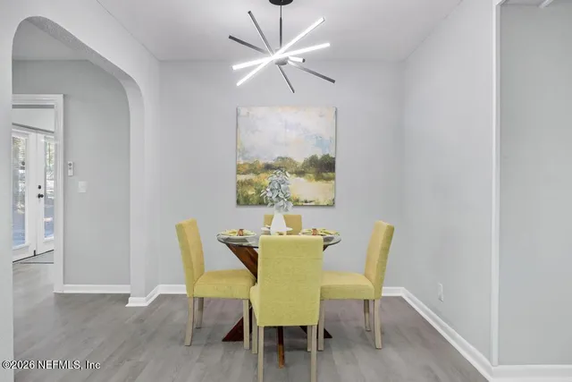 a view of a dining room with furniture and a chandelier