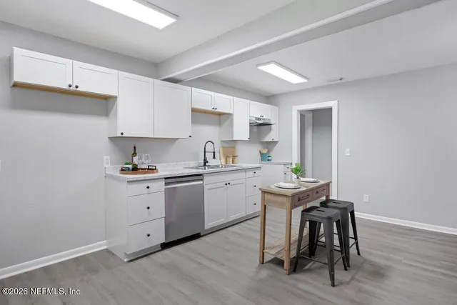 a kitchen with sink cabinets and dining table chair