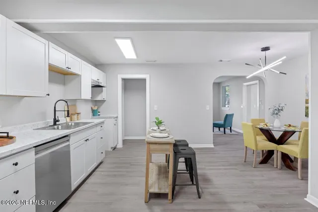 a kitchen with cabinets table and chairs