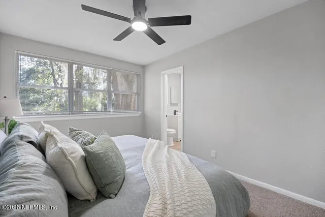 a bed sitting in a bedroom next to a window