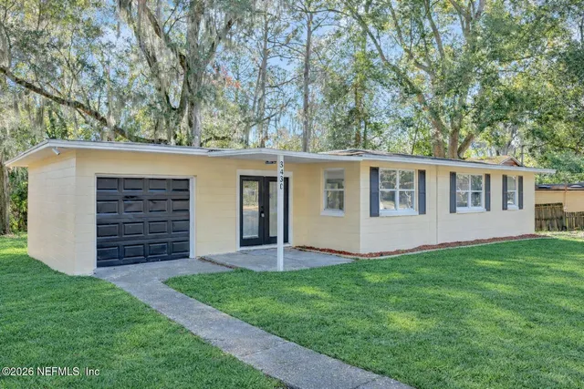 a view of a house with a yard and porch