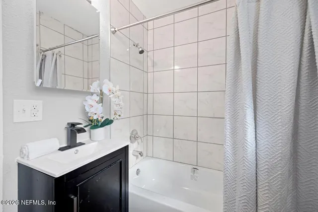 a bathroom with a sink vanity granite tub shower and vanity