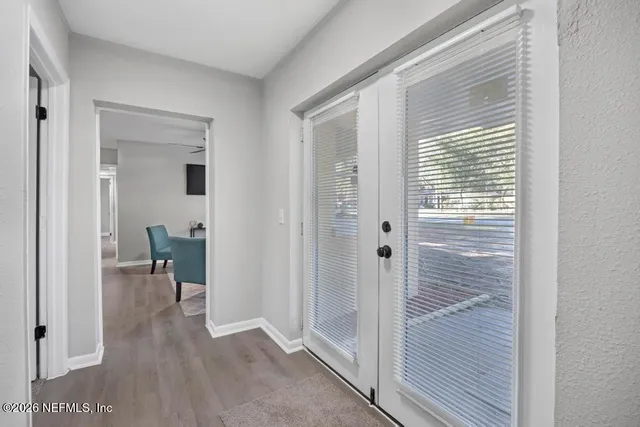 a view of a hallway with bathroom and a shower