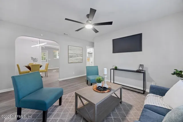 a living room with furniture a rug and a window