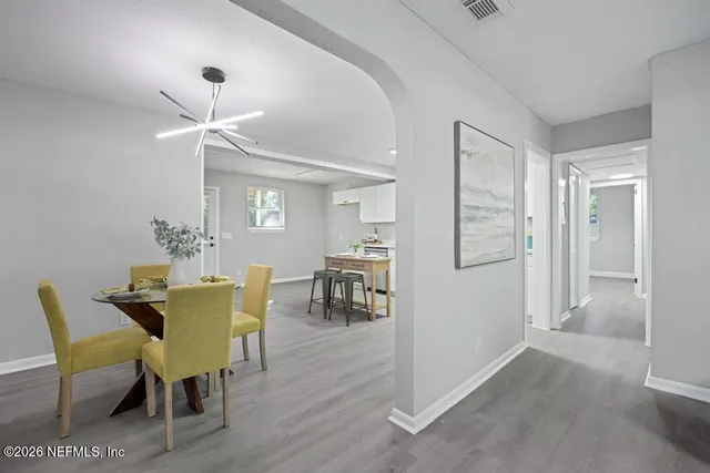 a view of a dining room with furniture and wooden floor