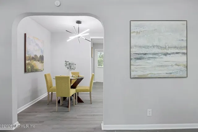 a view of a dining room with furniture and wooden floor