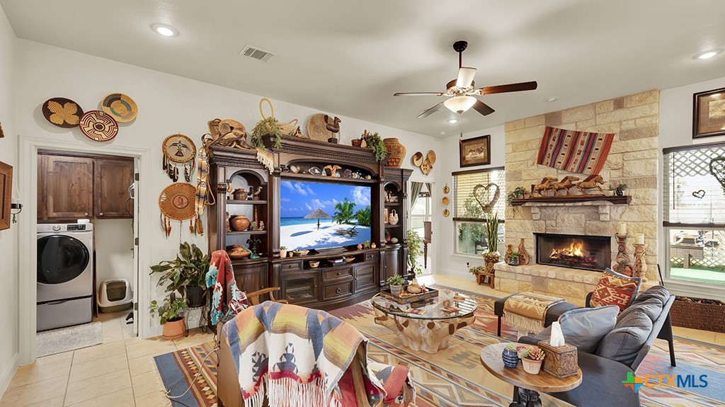 343 Meadow Valley Loop Jarrell, TX 76537 - Photo 11 of 33 a living room with furniture and a fireplace