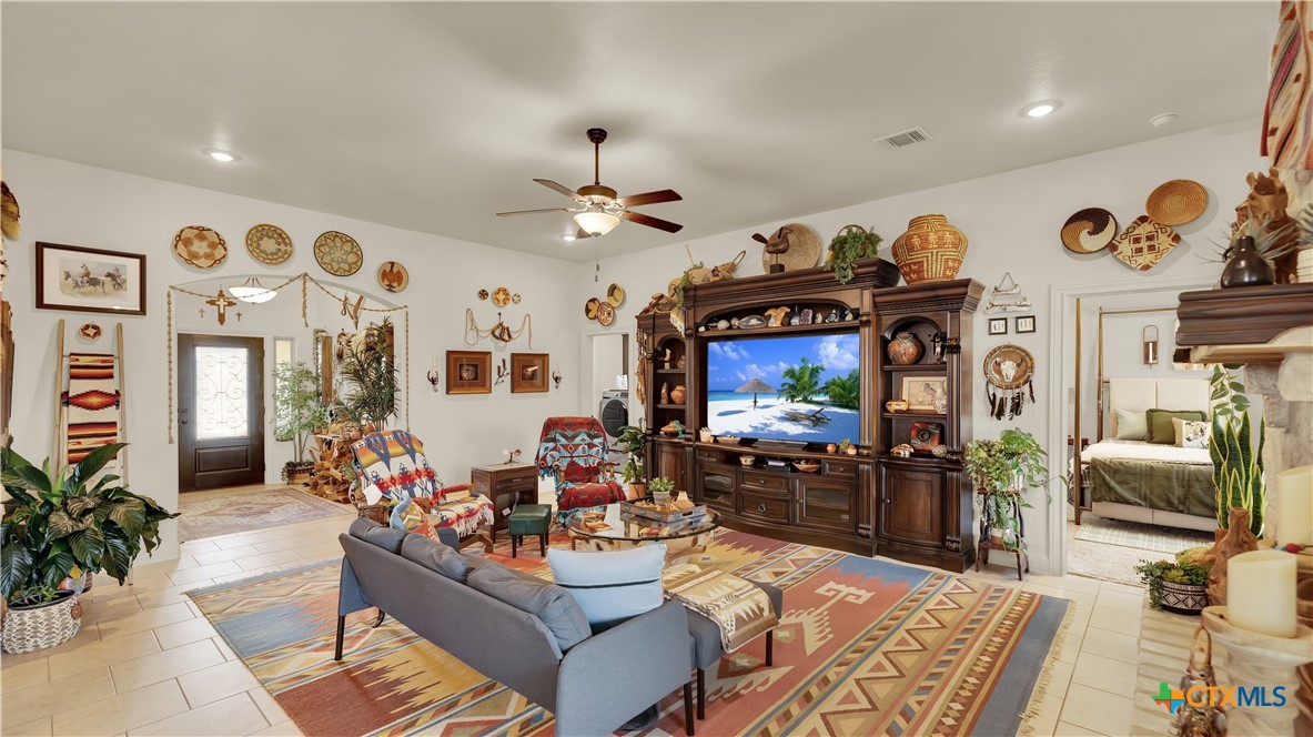 343 Meadow Valley Loop Jarrell, TX 76537 - Photo 12 of 33 a very nice looking living room with furniture and a chandelier
