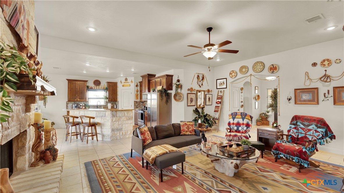 343 Meadow Valley Loop Jarrell, TX 76537 - Photo 13 of 33 a living room with furniture kitchen view and a chandelier