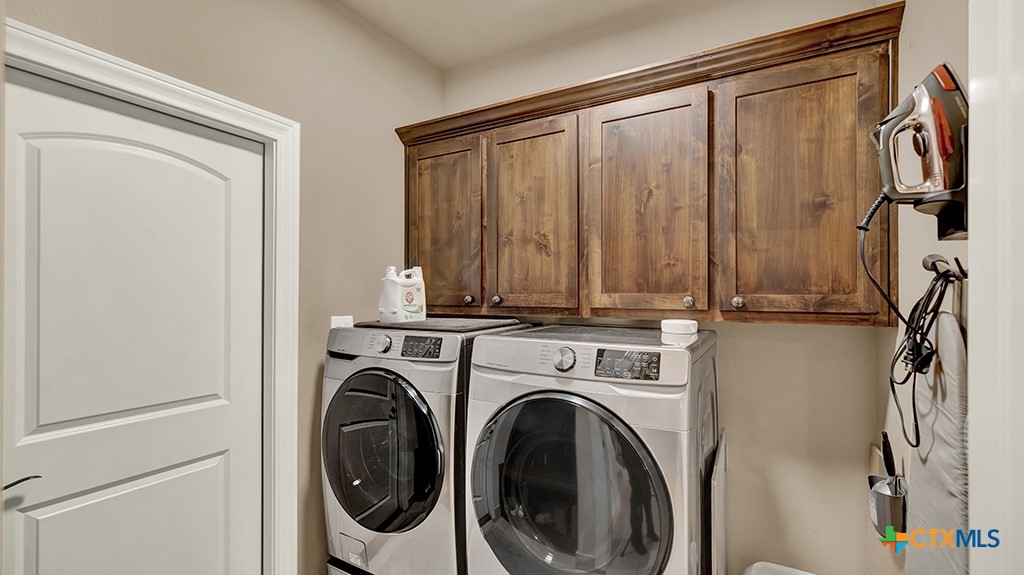 343 Meadow Valley Loop Jarrell, TX 76537 - Photo 15 of 33 a view of a storage & utility room with dryer and washer