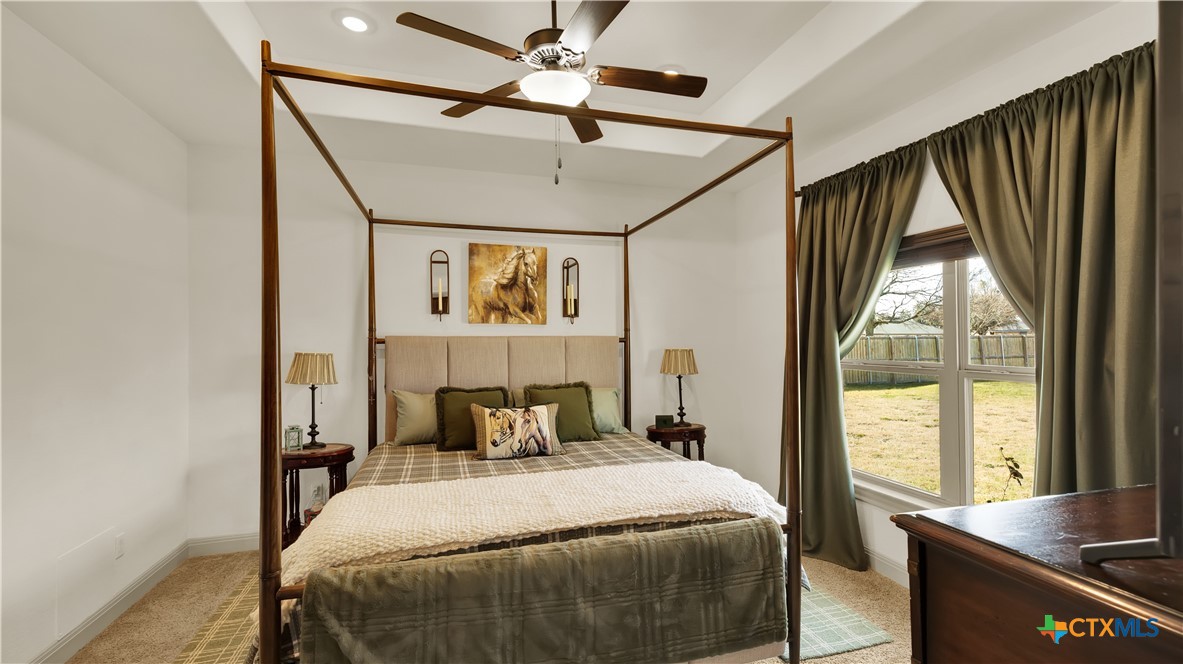 343 Meadow Valley Loop Jarrell, TX 76537 - Photo 16 of 33 a bedroom with a bed and a large window with the outer view