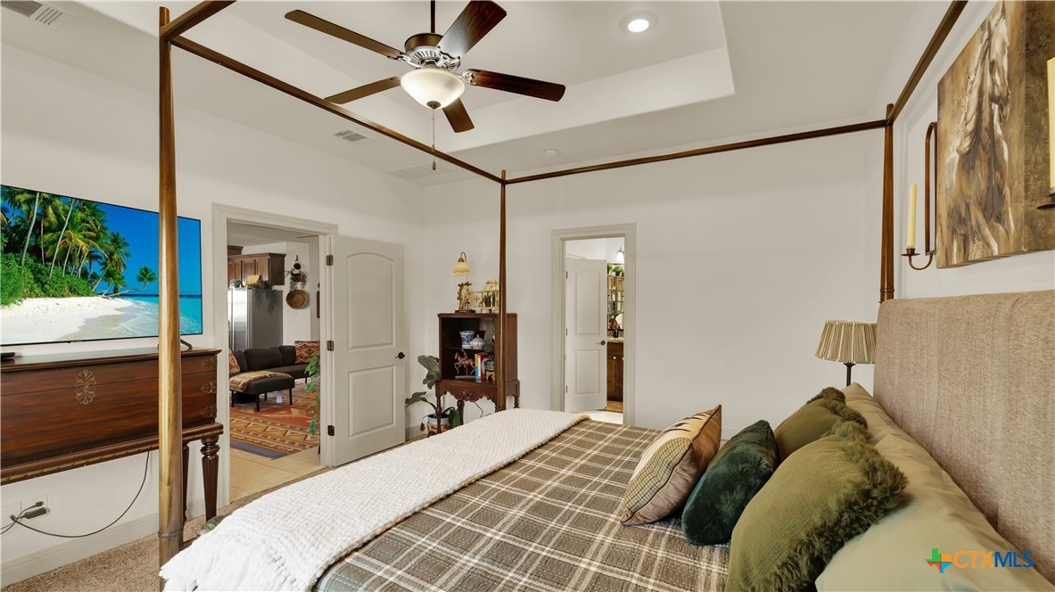 343 Meadow Valley Loop Jarrell, TX 76537 - Photo 17 of 33 a bedroom with a bed and a view of bathroom