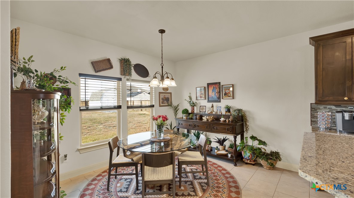 343 Meadow Valley Loop Jarrell, TX 76537 - Photo 22 of 33 a view of a dining room with furniture window and outside view