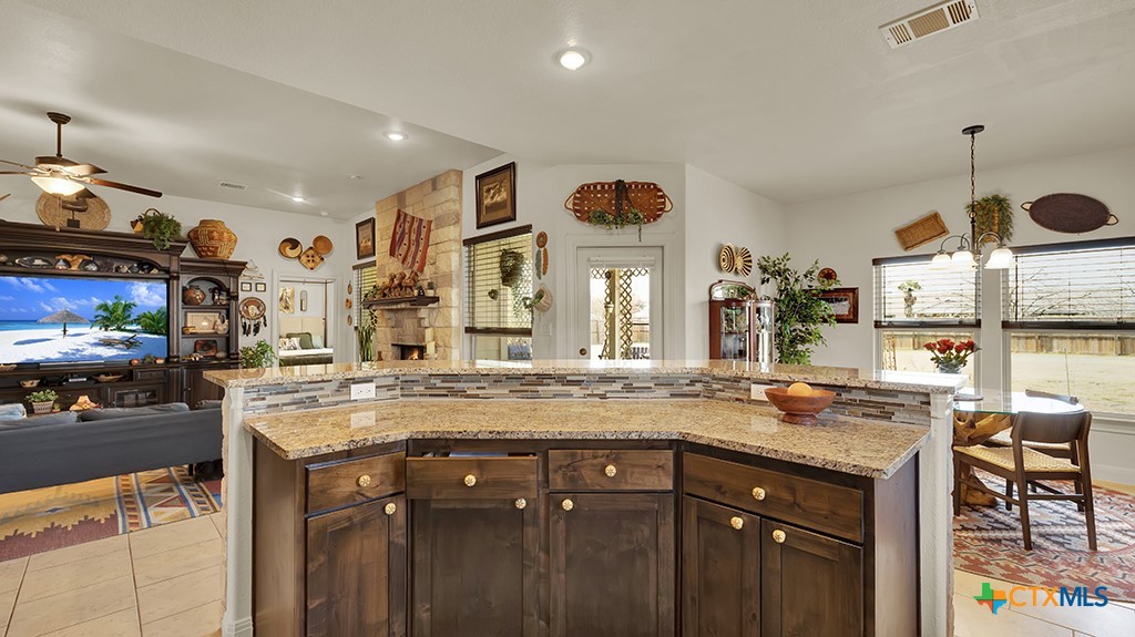 343 Meadow Valley Loop Jarrell, TX 76537 - Photo 27 of 33 a kitchen with a sink a counter and chairs