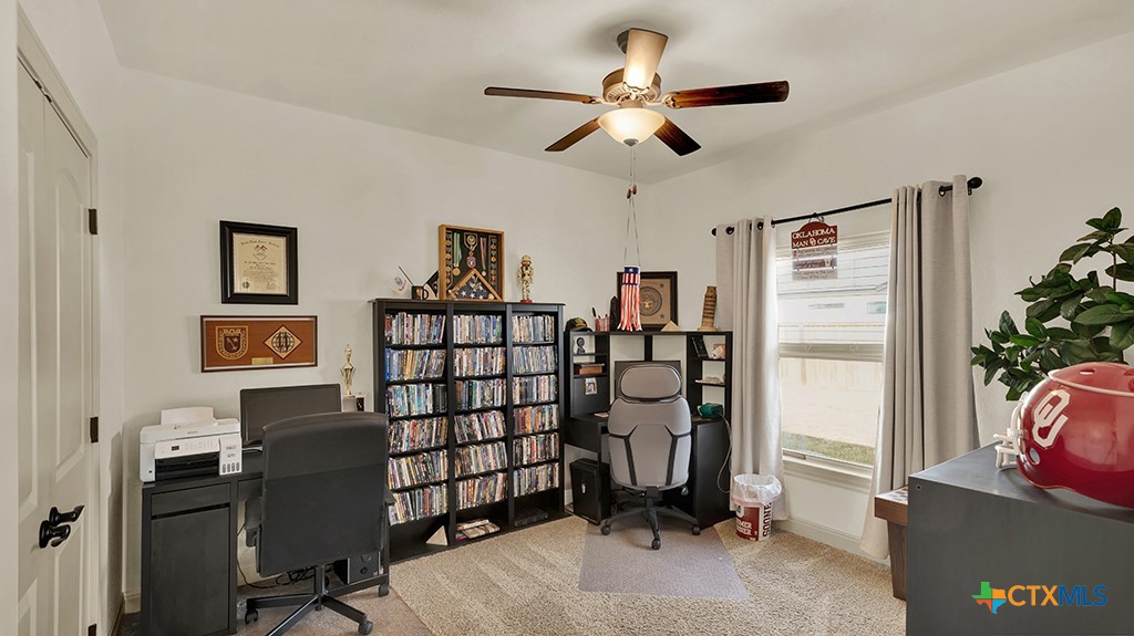 343 Meadow Valley Loop Jarrell, TX 76537 - Photo 7 of 33 a view of a workspace with furniture and a ceiling fan