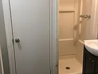 a bathroom with a shower and a sink