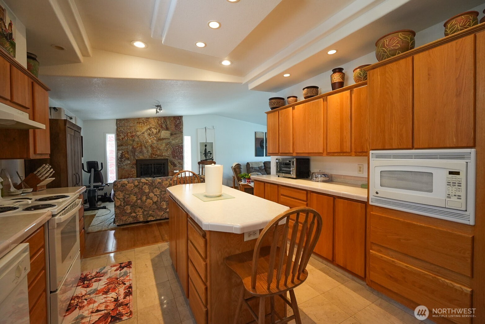 201 South Cherry Street Dayton, WA 99328 - Photo 11 of 23 a kitchen with stainless steel appliances granite countertop a sink a stove a refrigerator cabinets and chairs
