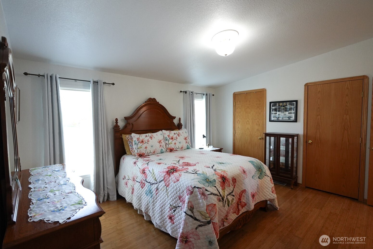 201 South Cherry Street Dayton, WA 99328 - Photo 19 of 23 a bedroom with a bed and wooden floor