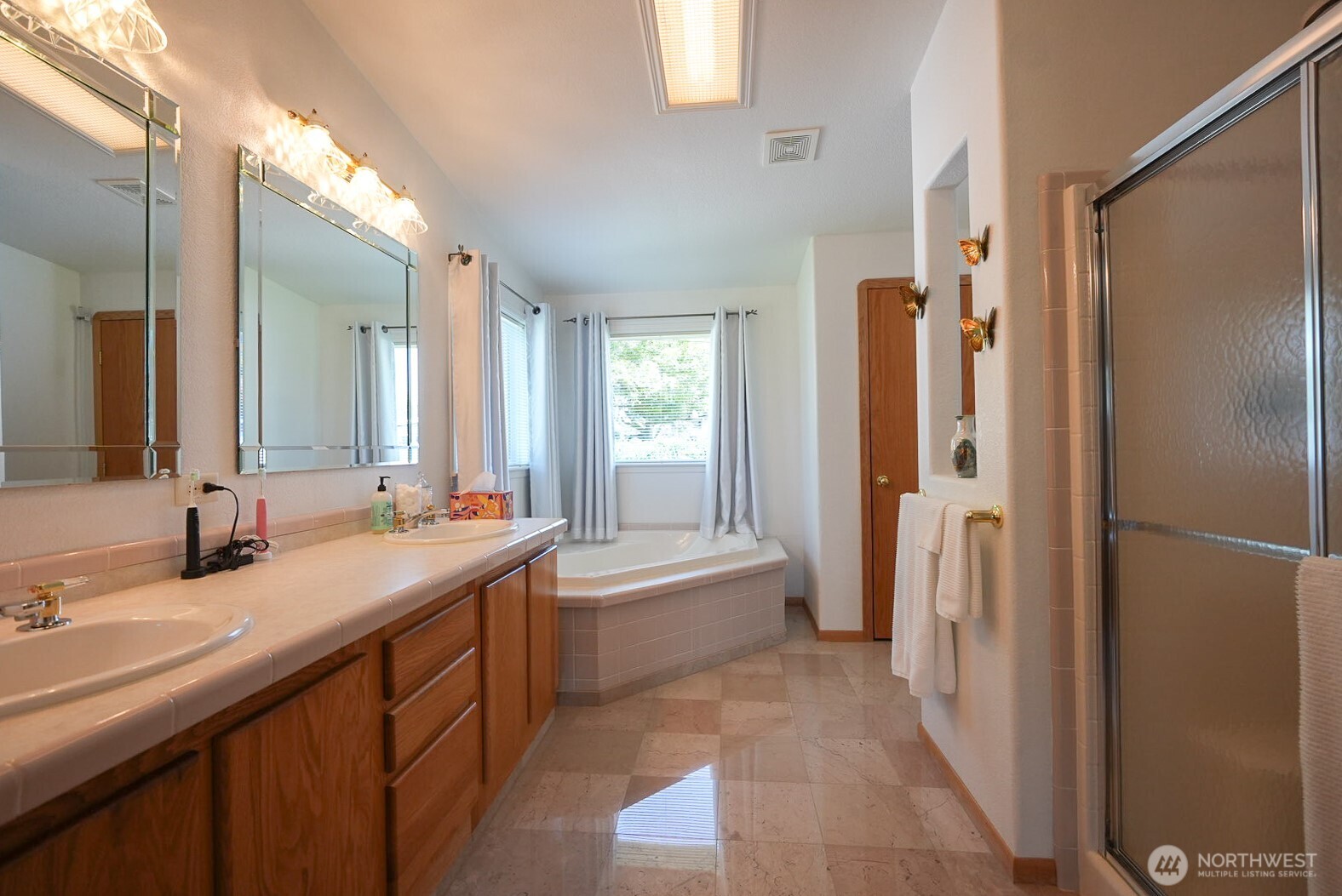 201 South Cherry Street Dayton, WA 99328 - Photo 21 of 23 a bathroom with a double vanity sink a mirror and a bathtub