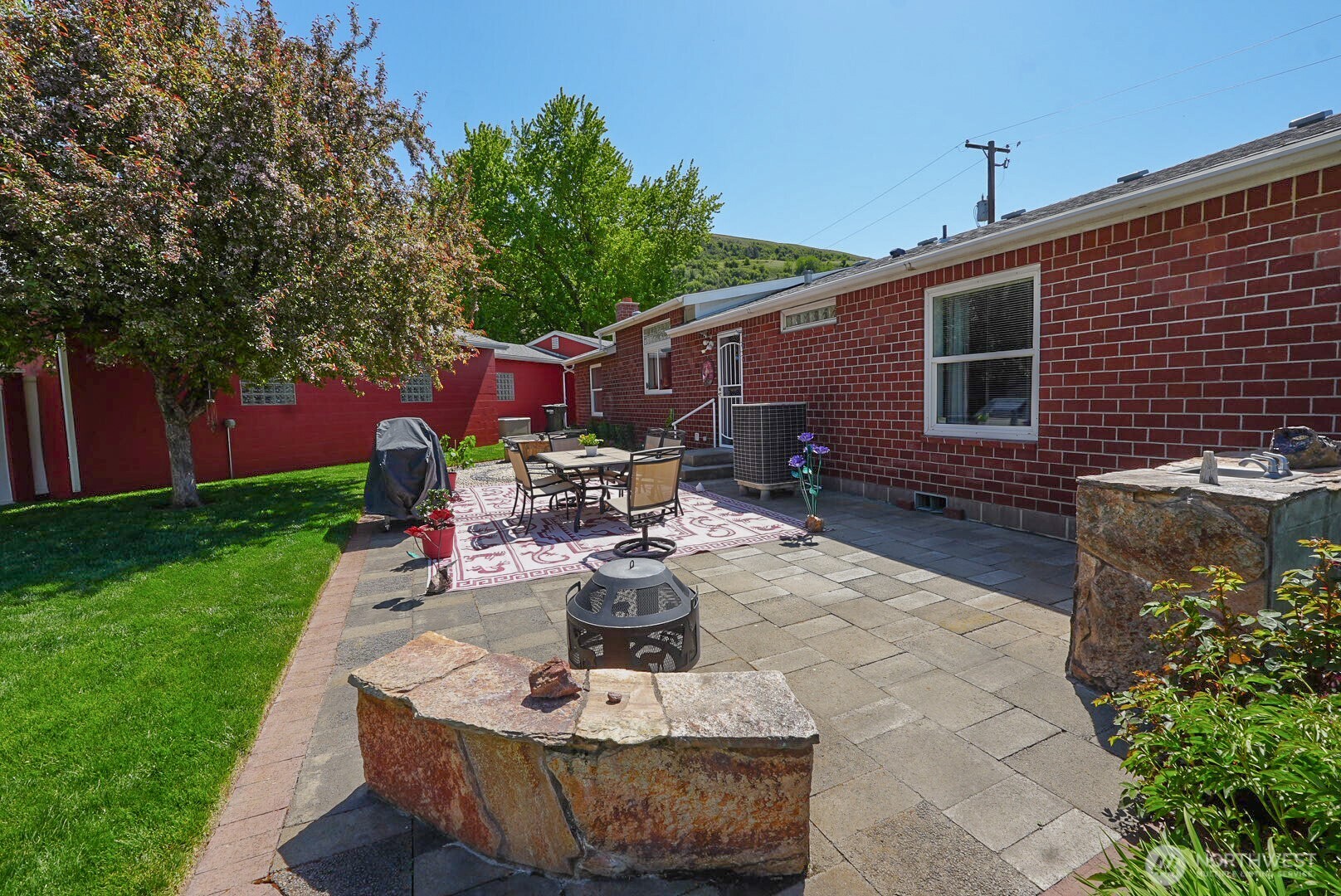 201 South Cherry Street Dayton, WA 99328 - Photo 5 of 23 a view of a house with backyard sitting area and garden