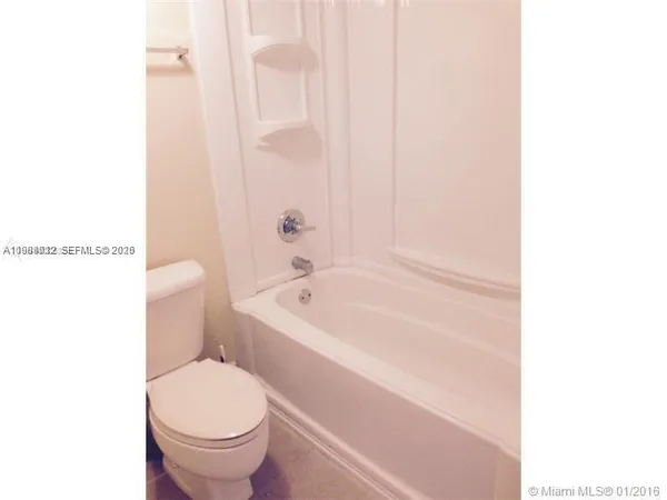 a bathroom with a toilet and a bathtub