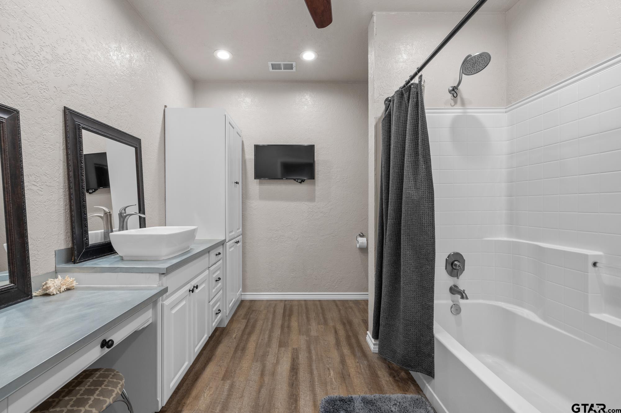 732 Red Maple Road Big Sandy, TX 75755 - Photo 14 of 40 a bathroom with a granite countertop sink a large mirror and shower