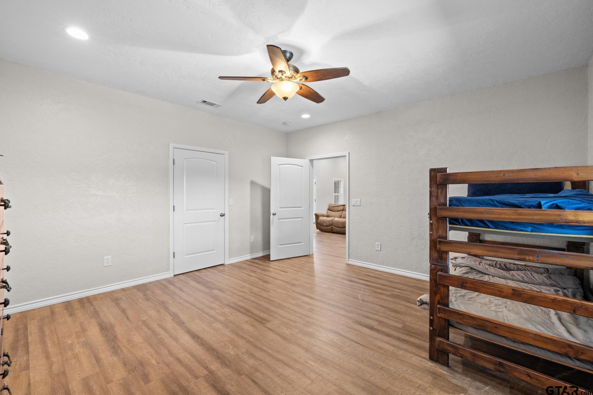 732 Red Maple Road Big Sandy, TX 75755 - Photo 18 of 40 a view of empty room with wooden floor and fan