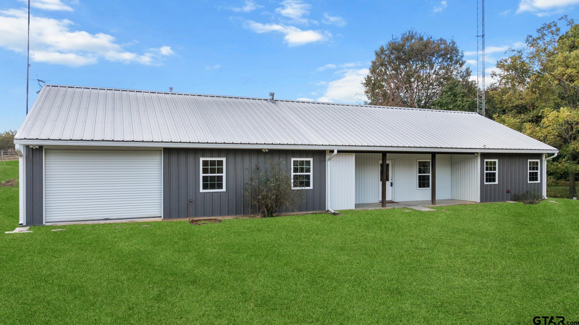 732 Red Maple Road Big Sandy, TX 75755 - Photo 19 of 40 a front view of a house with a yard and garage