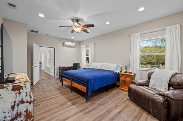 a bedroom with a bed couch and window